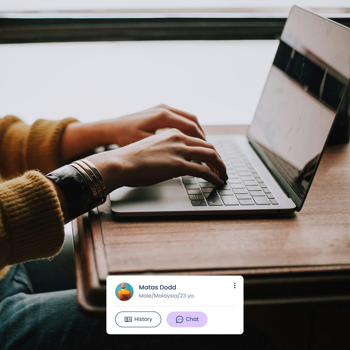 Person typing on a laptop and a SafeTalk client card